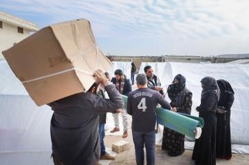People carrying shipments of emergency supplies.