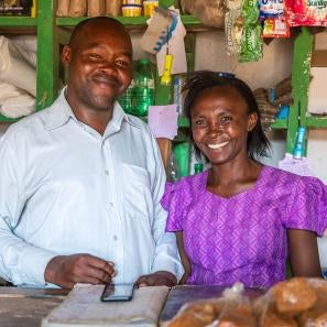 Lydia and her husband at their small shop. lydia relies on rain-fed agriculture to support her family, a livelihood that has become increasingly fragile with the growing effects of climate change. photo: ezra millstein for prosper global