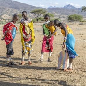 Kenyan women meeting in the outdoors.