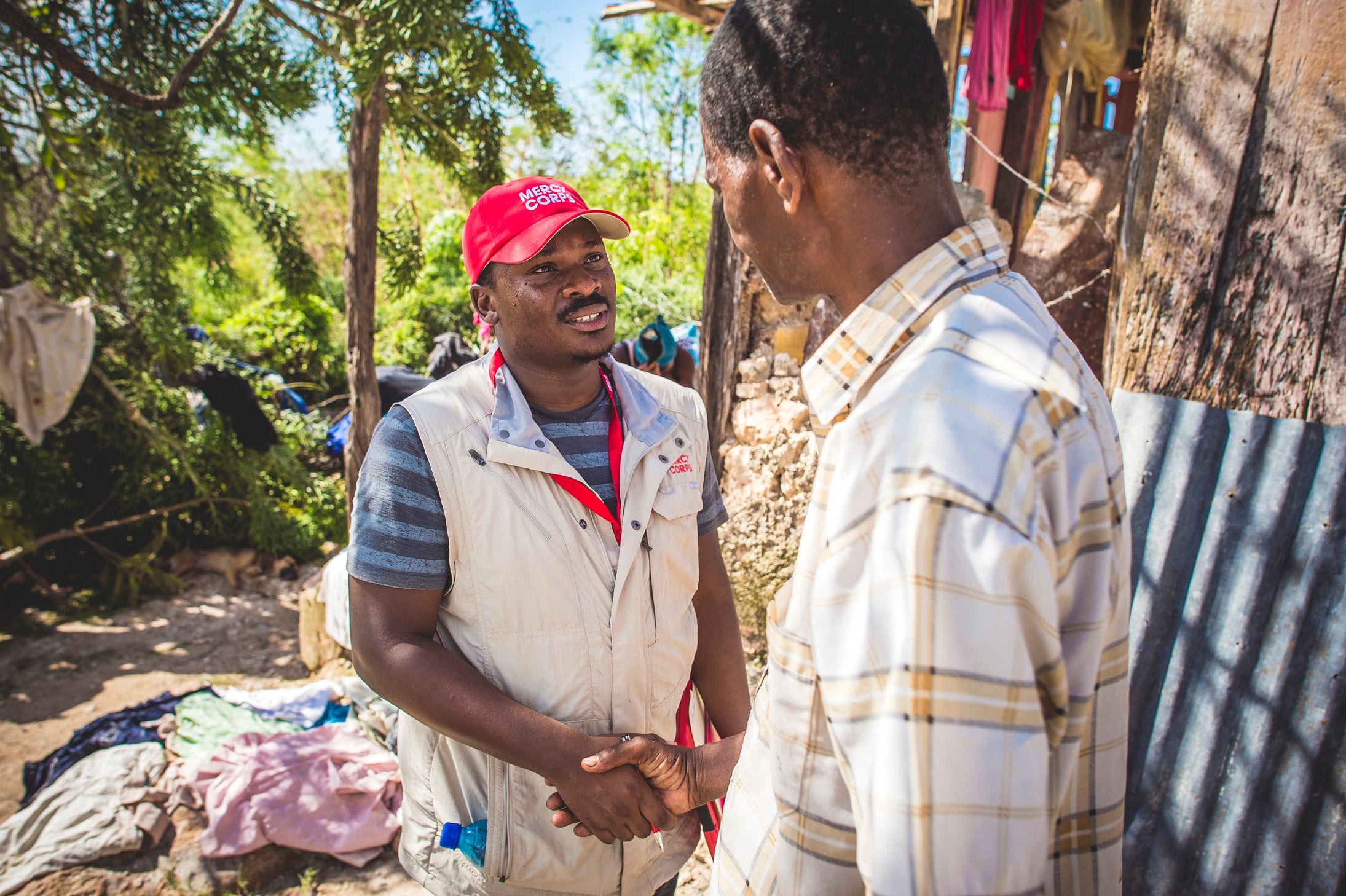 Prosper Global employee shaking hands with Haitian hurricane victim