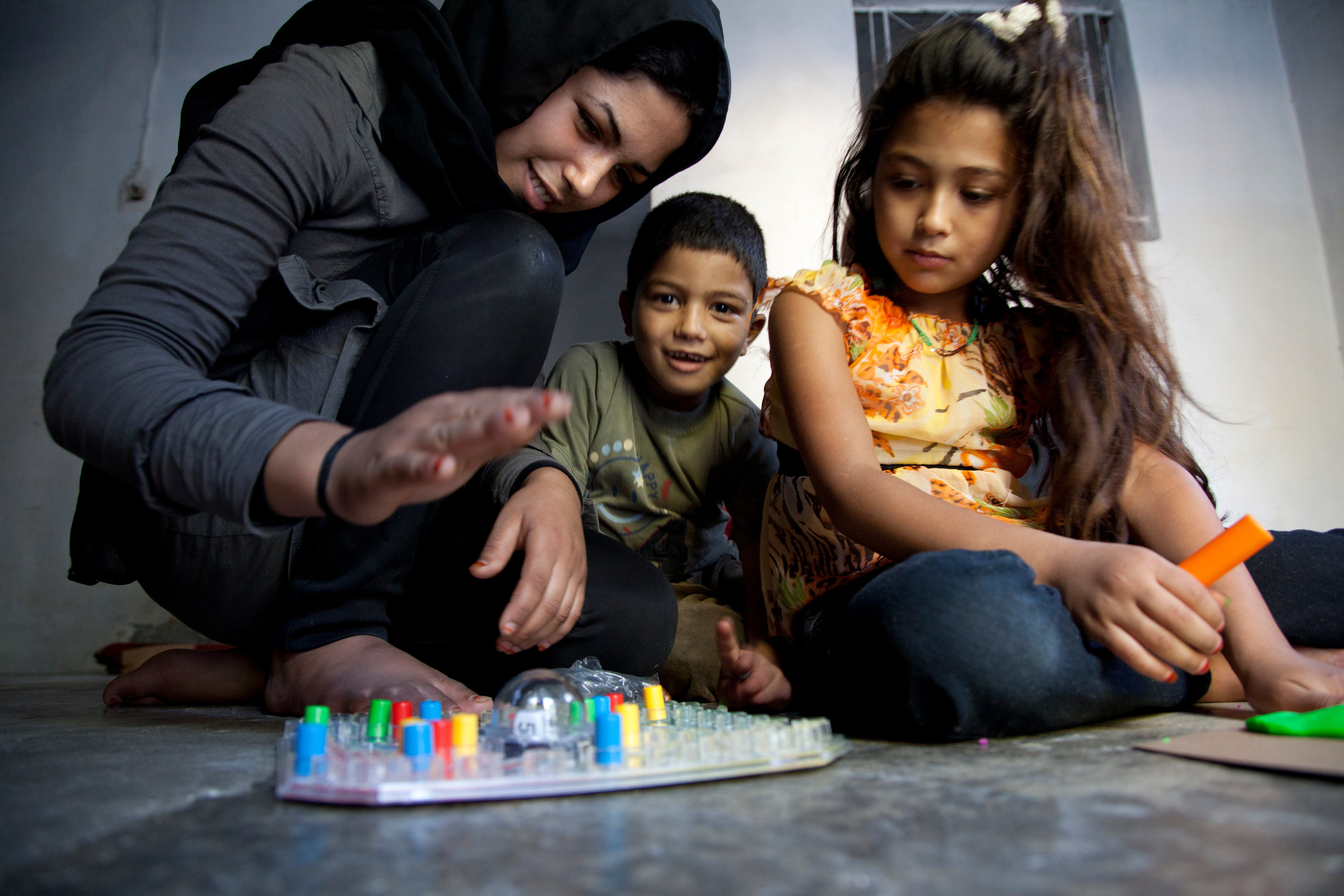 A young boy and girl playing a board game
