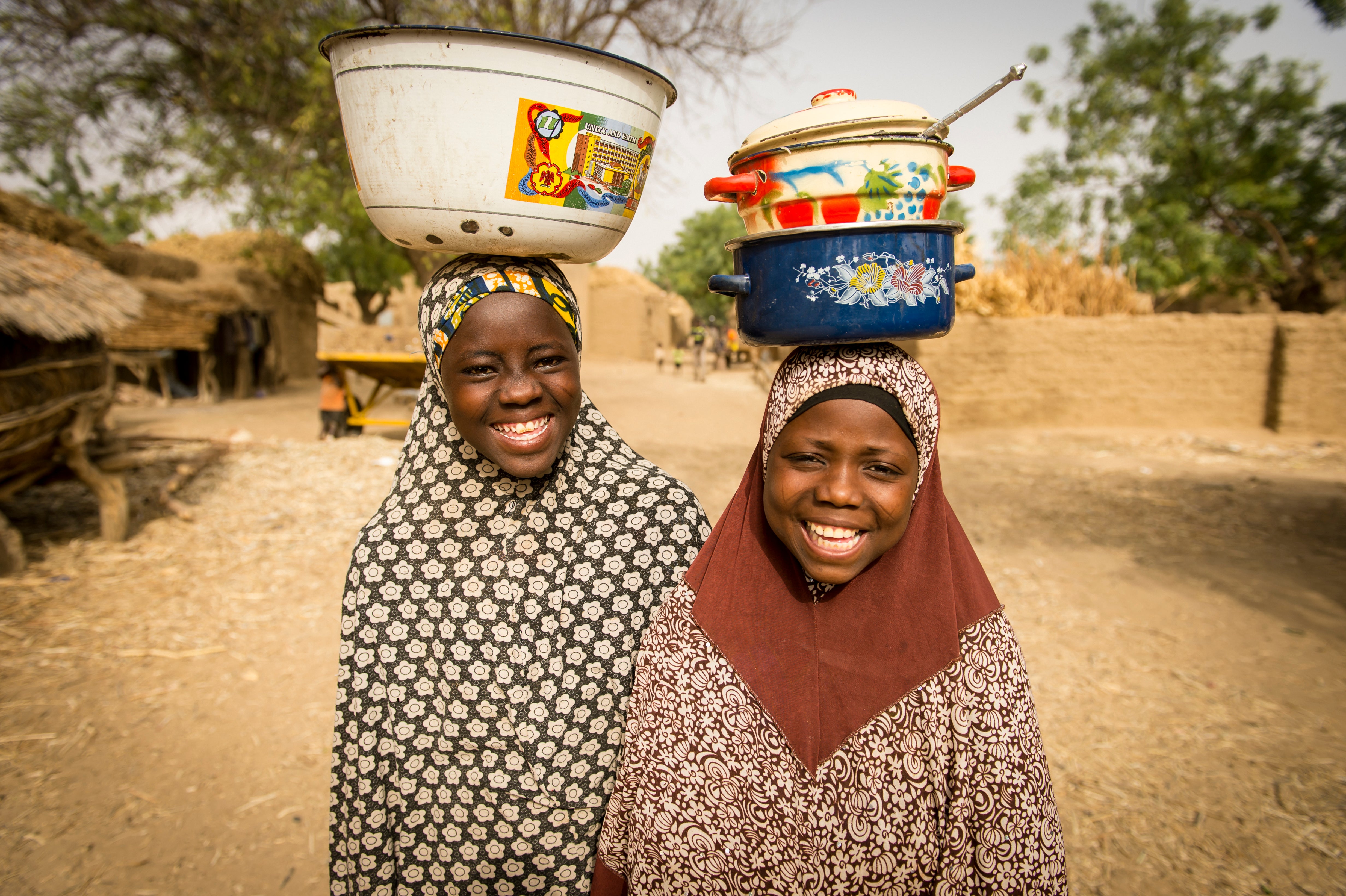Friends Mariya and Badariya in Niger after participating in one of Prosper Global's discussion groups for girls. Photo: Sean Sheridan for Prosper Global