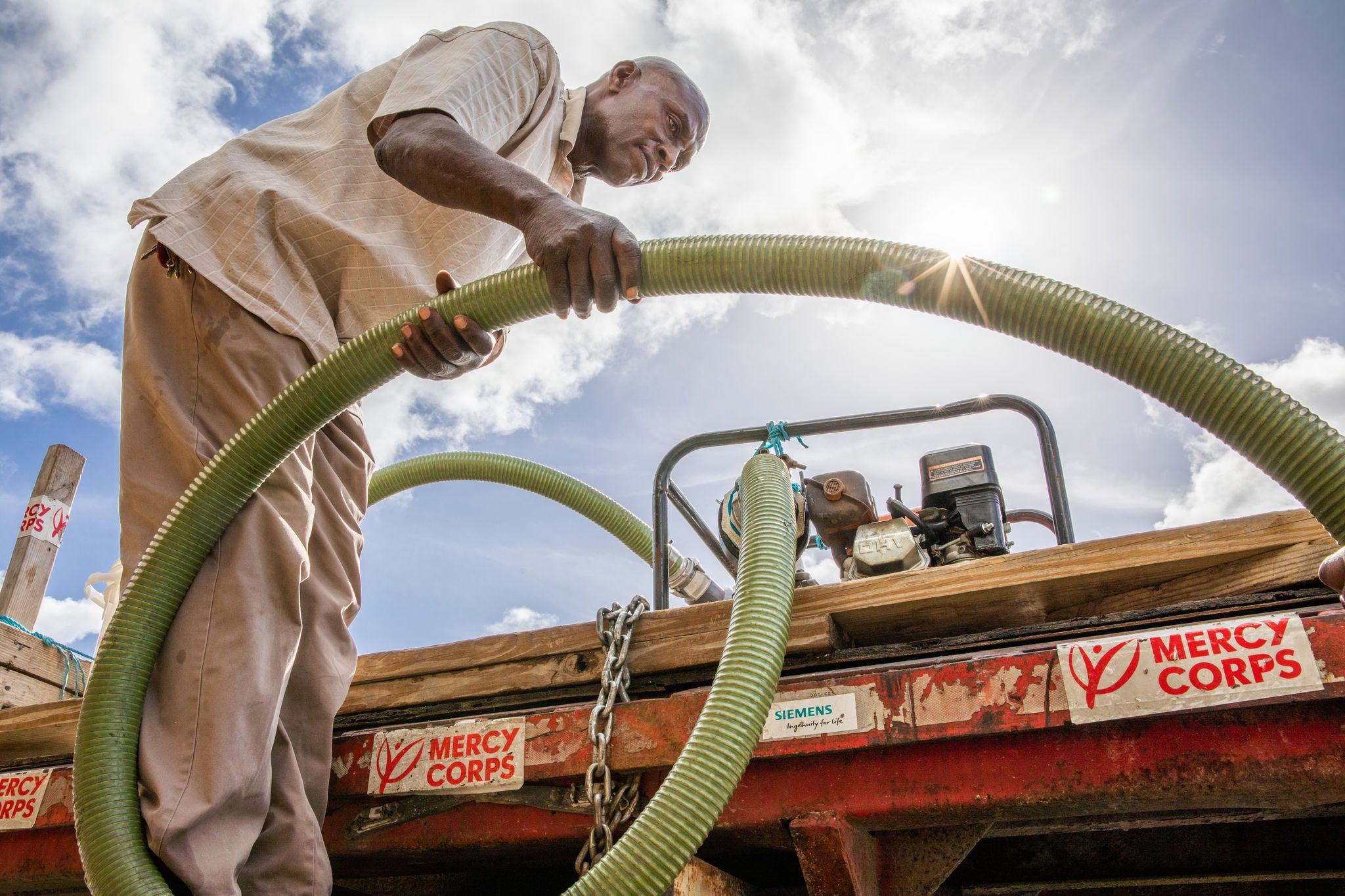 Bahamian working with a water tender truck.