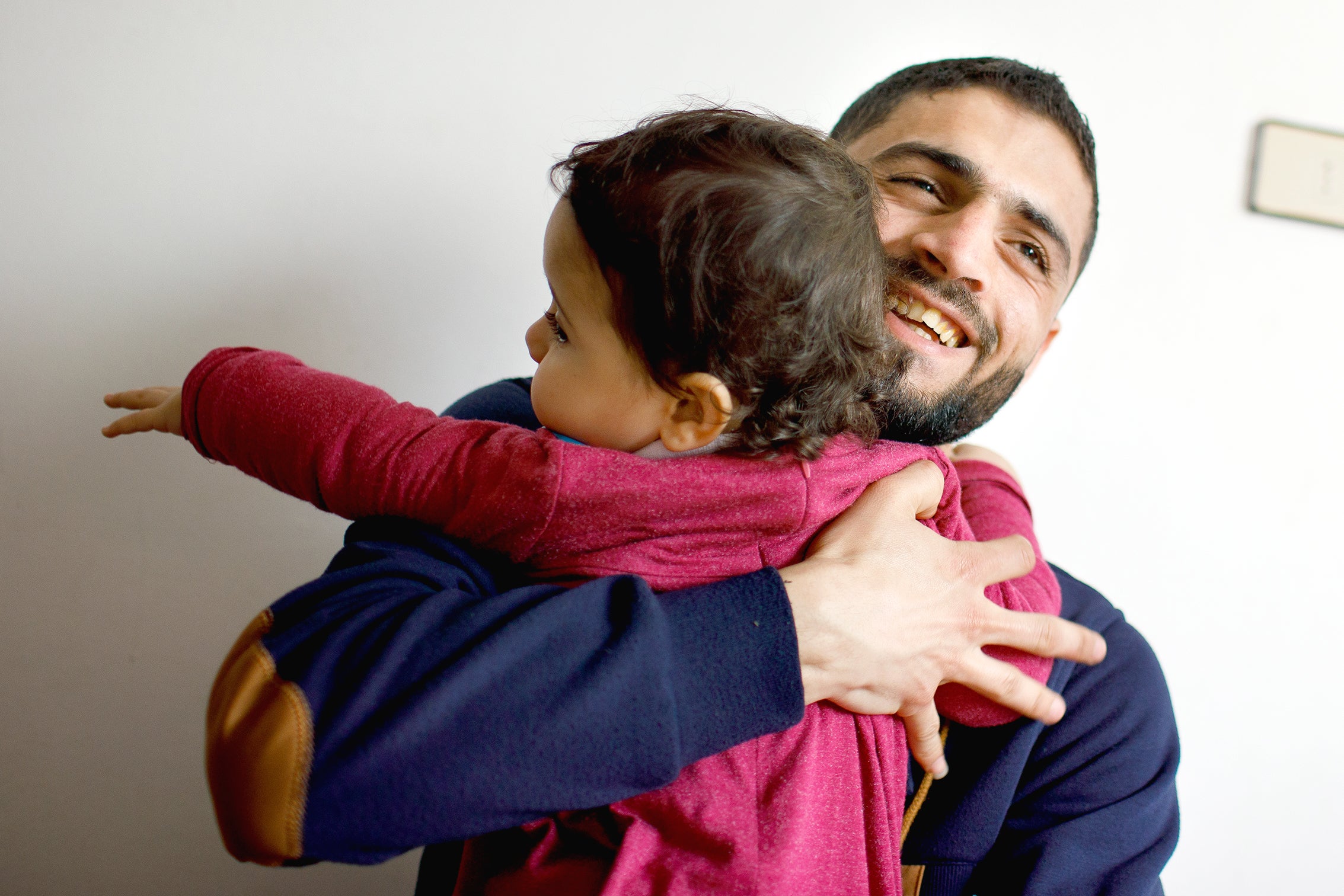 Father hugging child.