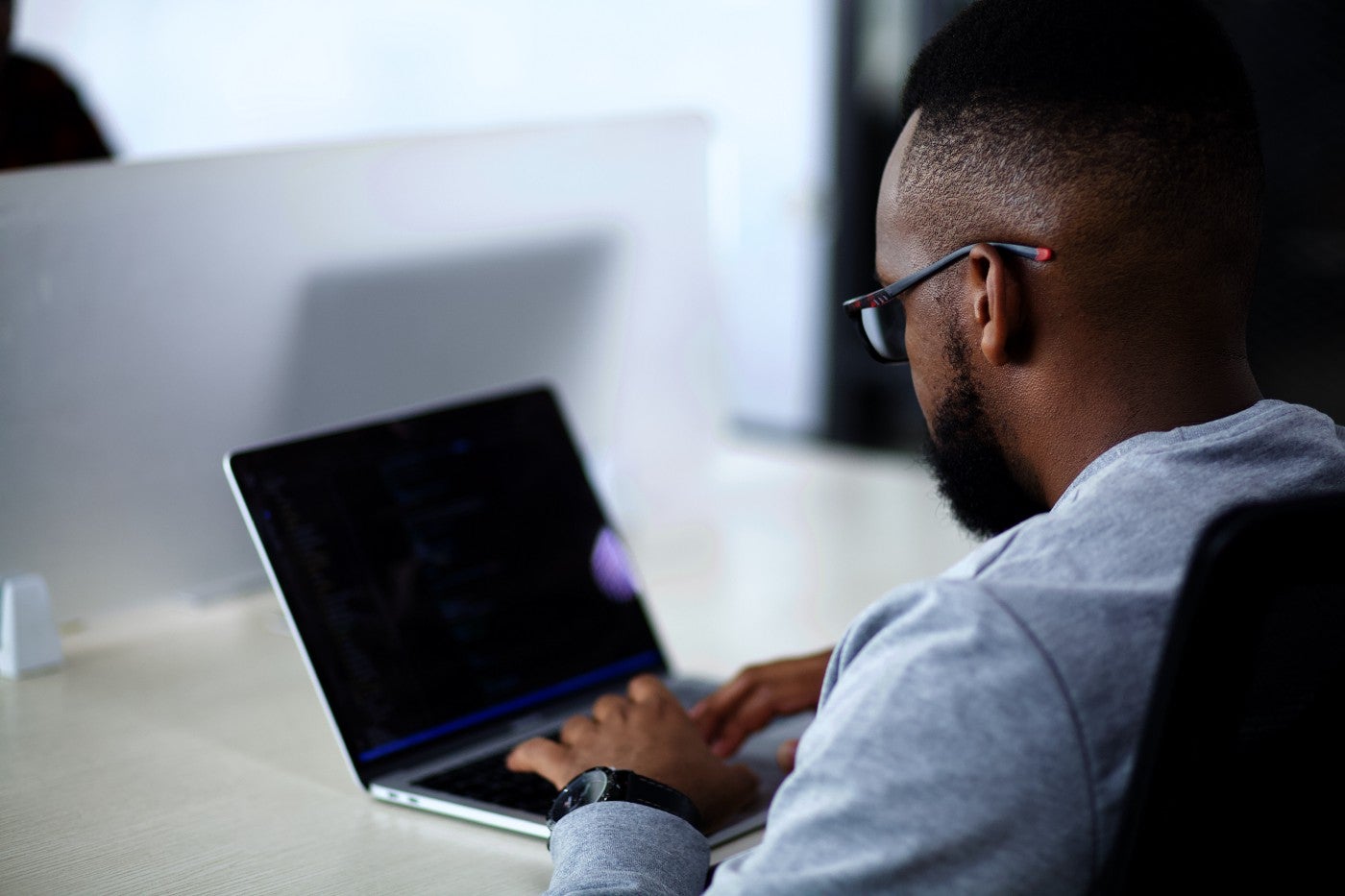 A person sits at a laptop computer.