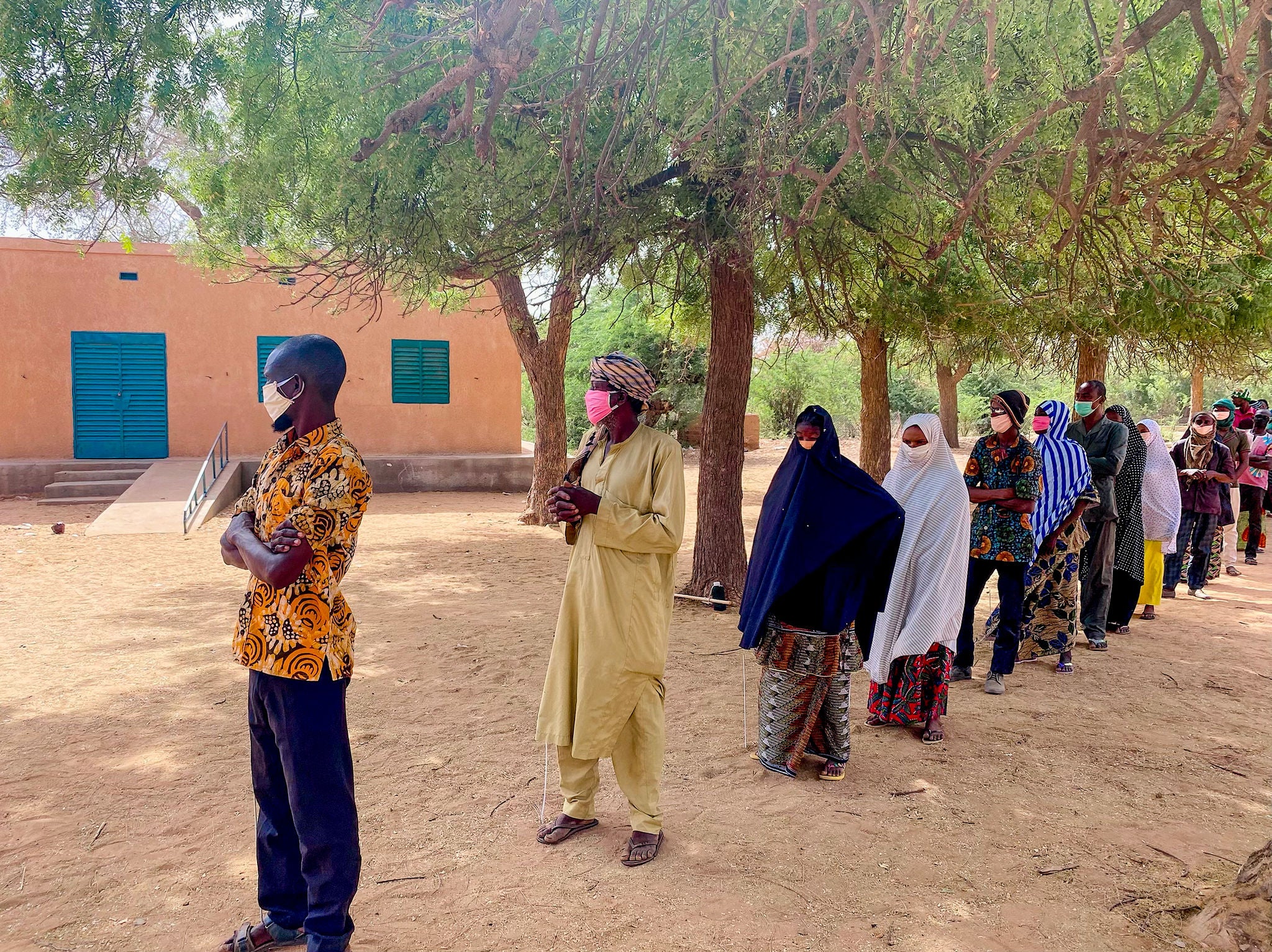 People line up six feet apart to keep from spreading COVID-19. 