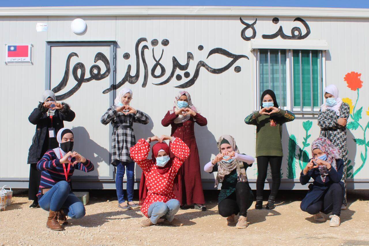 Women in Jordan making heart shapes with their hands