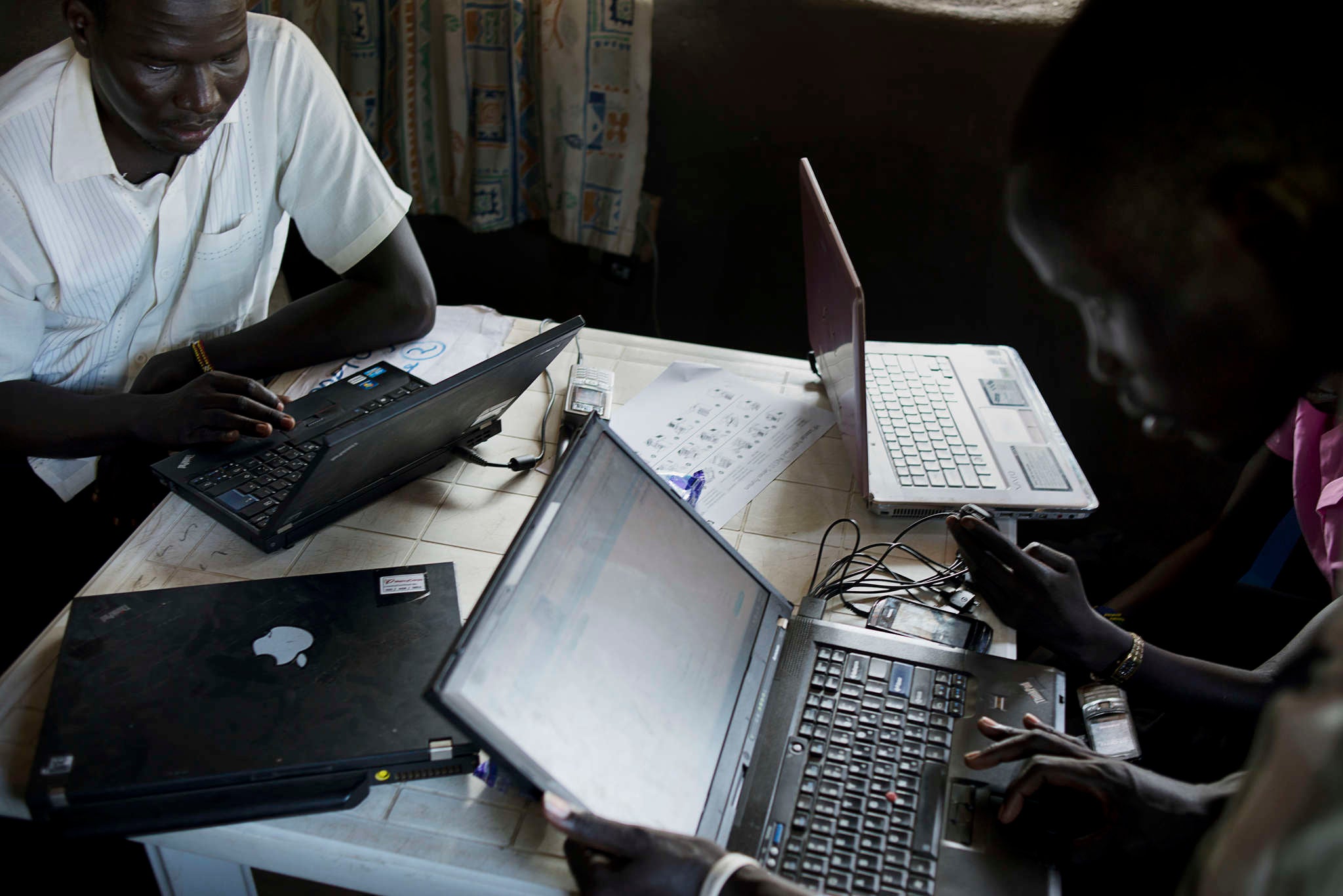 A group of people using laptop computers.