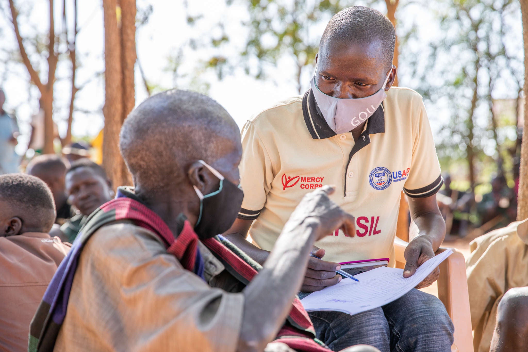 Prosper Global team member, James Longok, speaks with people in Karamoja during a peace-building session.