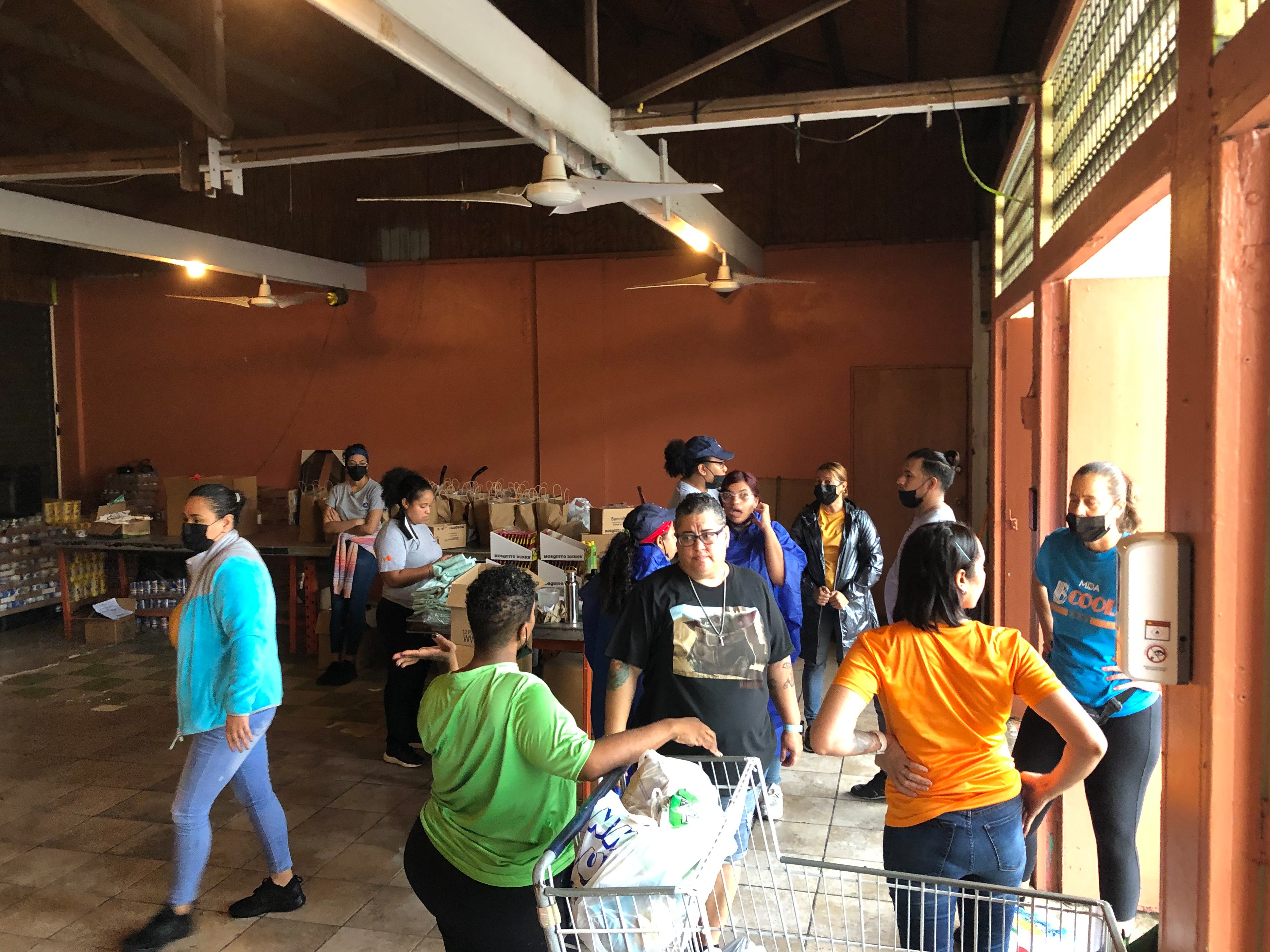 In Cataño, Puerto Rico, volunteers at Association Pro Juventud y Comunidad de Barrio Palmas, a Prosper Global Resilience Hub, prepare supplies for distribution. 