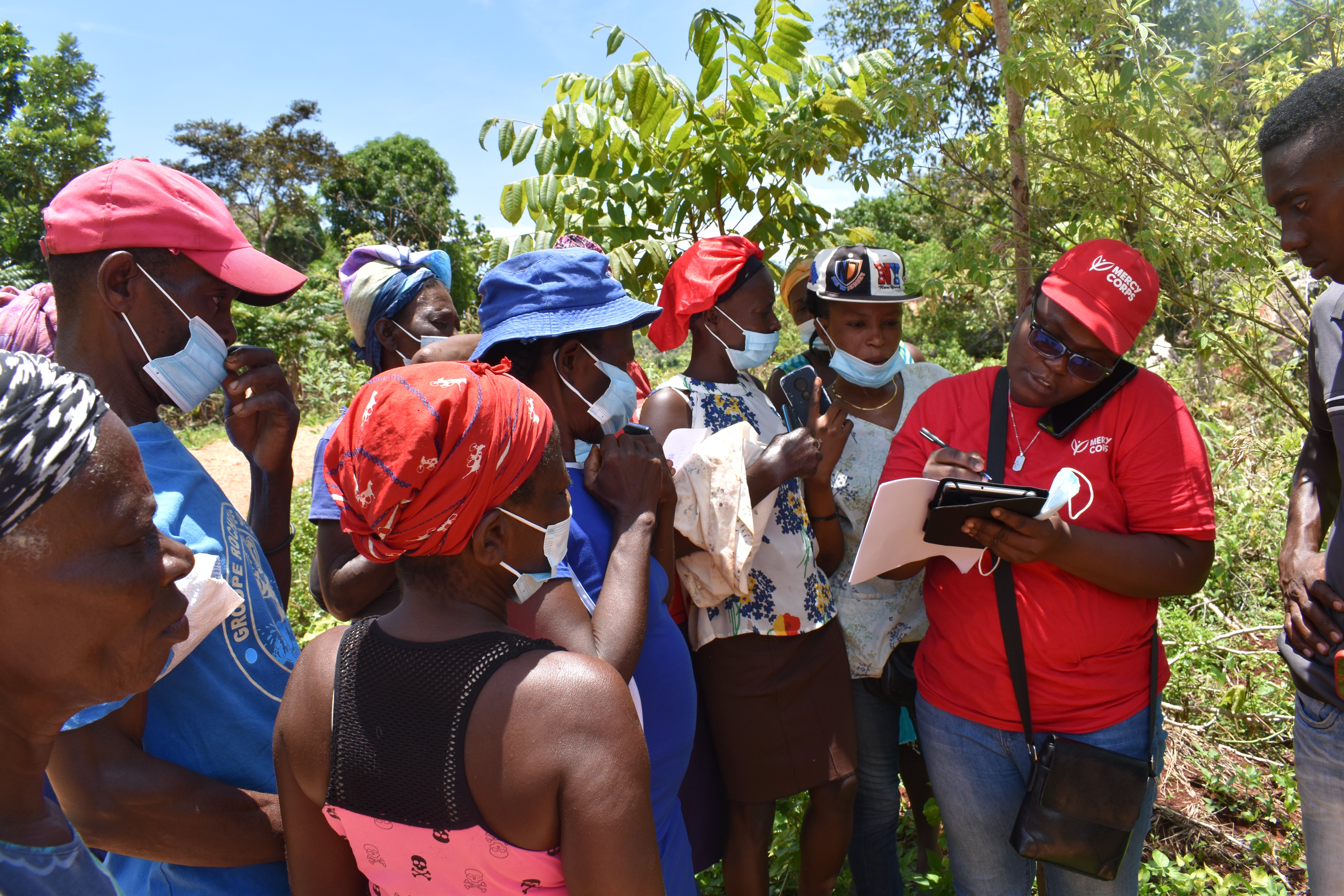 In Grand'Anse, Haiti, a Prosper Global team member helps farmers set up mobile accounts for emergency cash aid transfers. 
