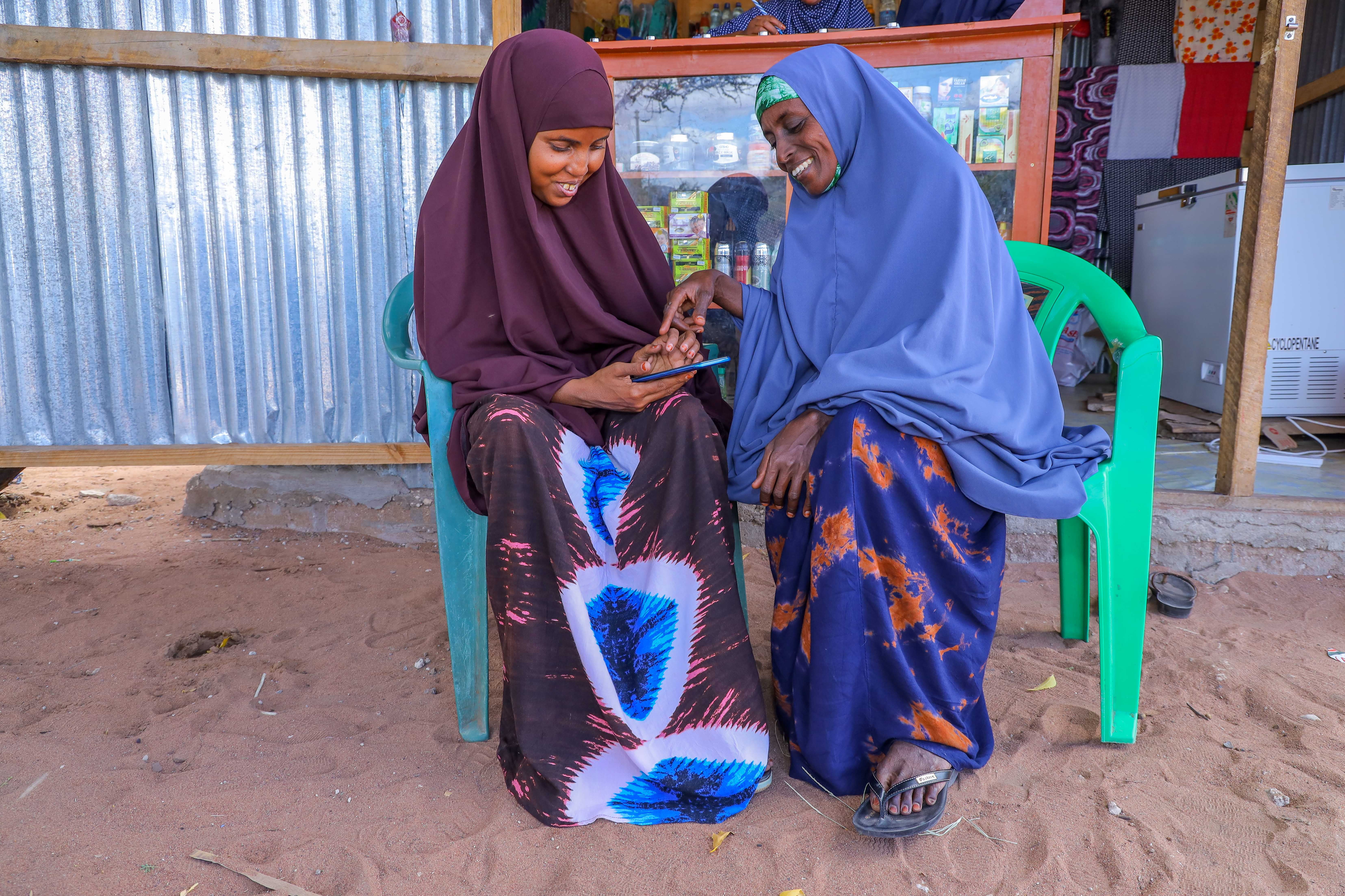 Two adults using a mobile phone.