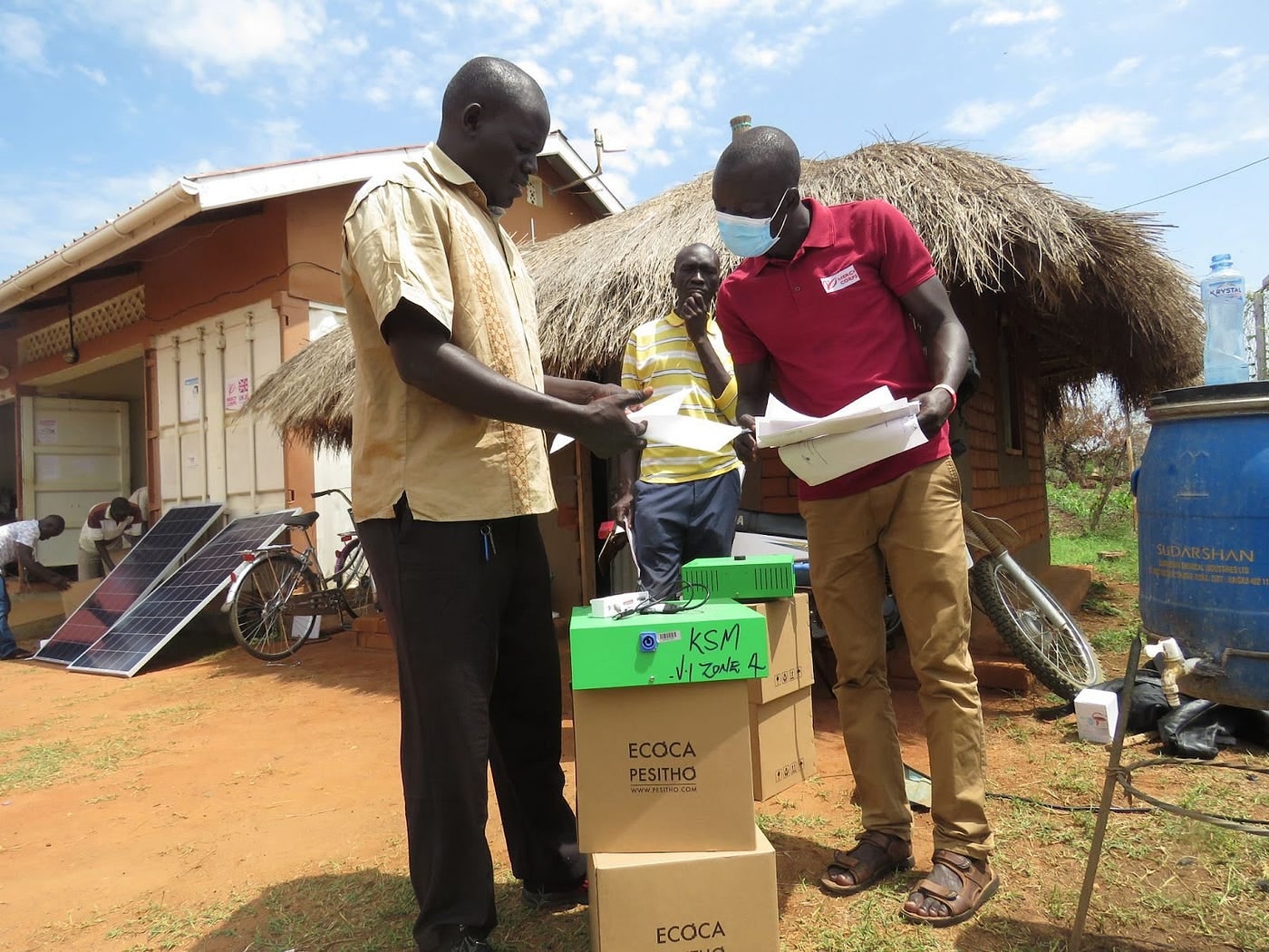 A Prosper Global member reviewing a participtants paper work in Uganda’s Bidi Bidi refugee settlement.
