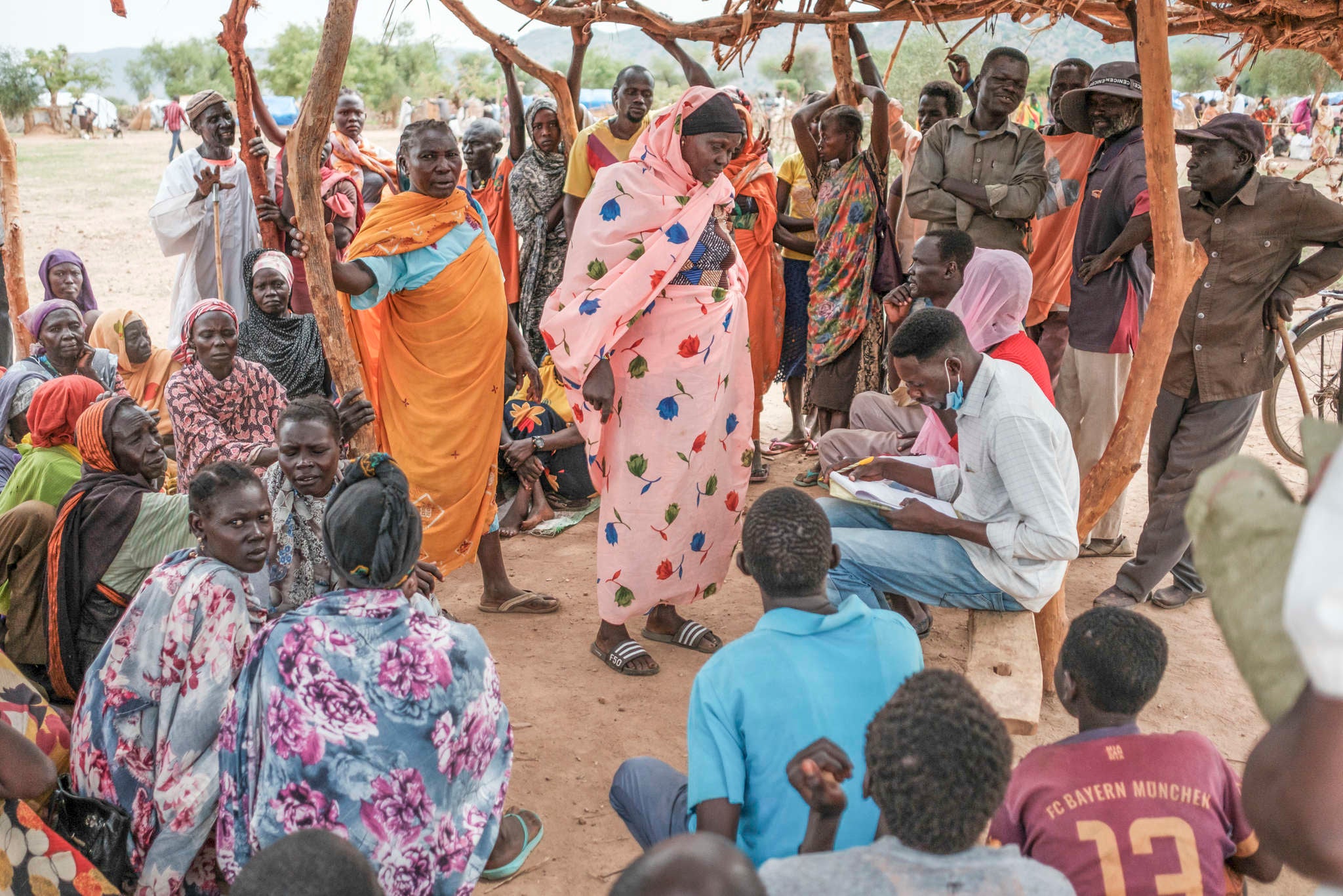 Families in Sudan wait to register for a food aid delivery.
