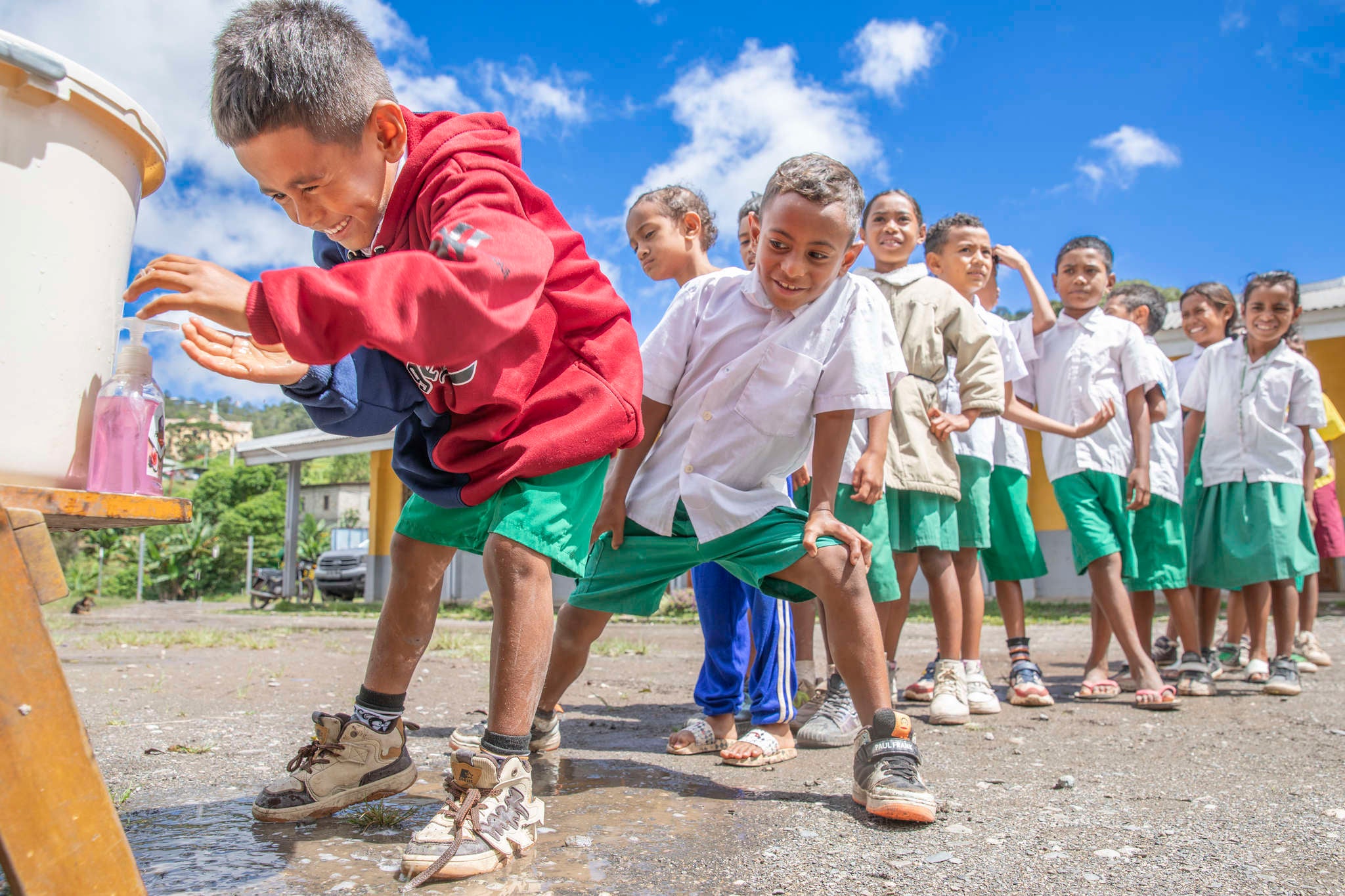Children line up to wash their hands before eating lunch at school in Maubisse Villa, Timor-Leste.