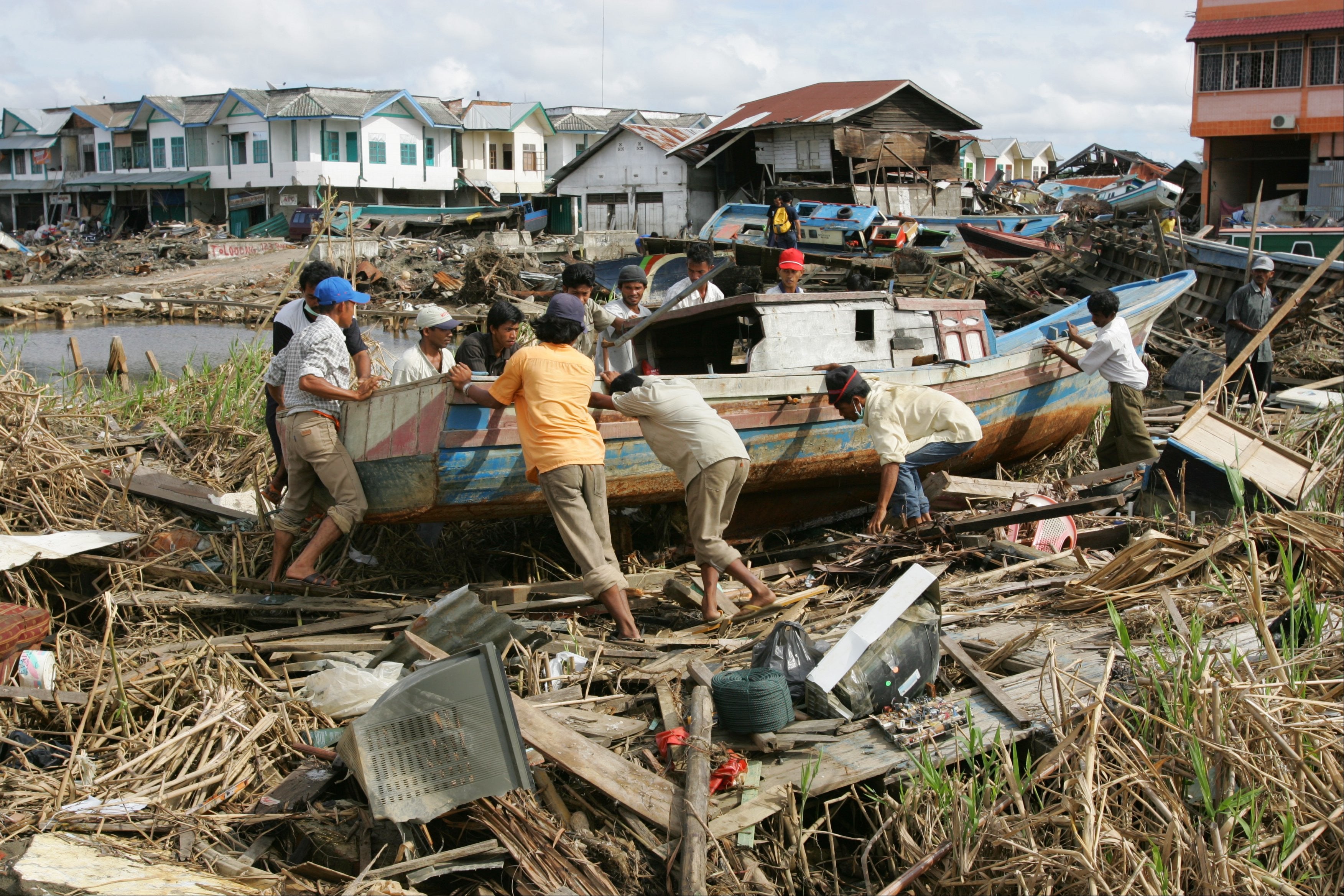 In Meulaboh, Indonesia, local fisherman clear boats and debris inland in the weeks after the devastating earthquake and tsunami in 2004.