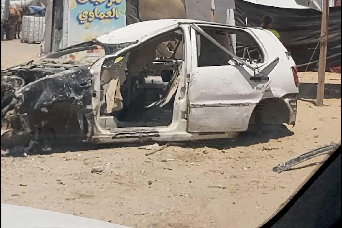 Destroyed automobile in the middle of a street in Gaza.