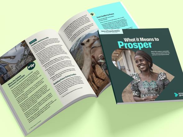 Image of voice of prosperity printed report open on straw-colored background.