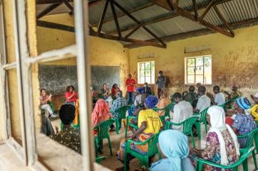 Chief executive officer of prosper global, tjada d’oyen mckenna talks to colleagues during her visit to bidi bidi refugee settlement.