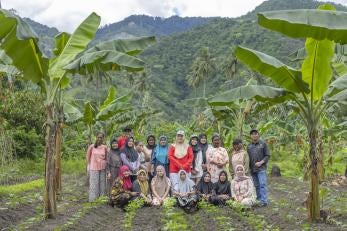 Group of indonesians, gather in agricultural field, a group with emergency preparedness strategies in place.