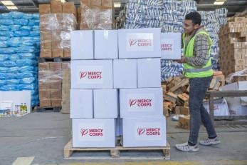 A prosper global team member loads a pallet with food kits to be delivered in gaza.