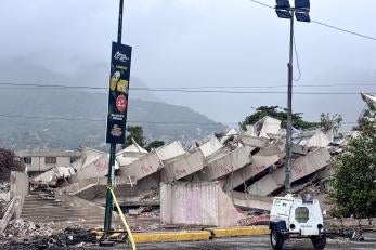 Collapsed building in venezuela with portable lighting in the foreground; this damage is due to major earthquakes that struck the country in june 2026.
