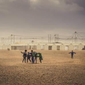 Boys playing near shelters at a refugee camp in jordan
