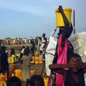 People gathered around water and supplies