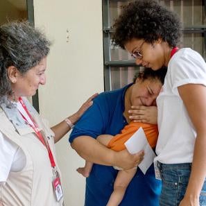 Prosper global team members karla peña, right, and pardis barjesteh, comfort a crying stephanie, 27, after she received cash and a water filtration system from them. photo: angel valentin for prosper global