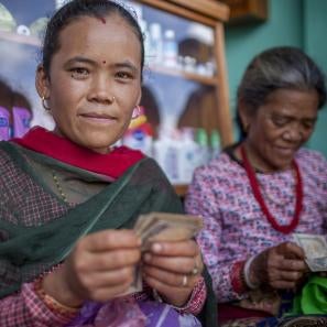 Two women handling money in a shop
