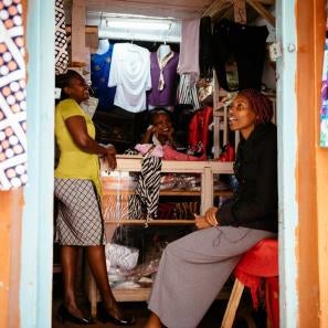 Zipporah with two other women inside the doorway of her store