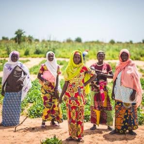 Women in niger standing in front of a field