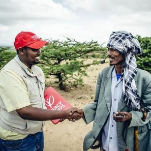 Prosper global employee shaking hands with a program participant