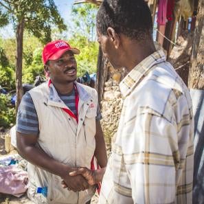 Prosper global employee shaking hands with haitian hurricane victim