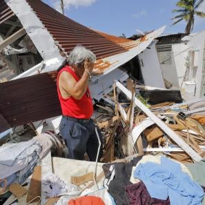 Man among hurricane maria rubble
