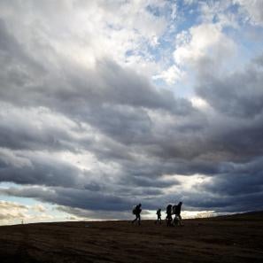 People walking with cloudy sky behind them in serbia