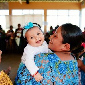 Woman with smiling baby in guatemala