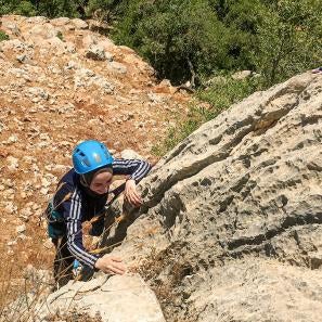 Climbing a rock face in jordan