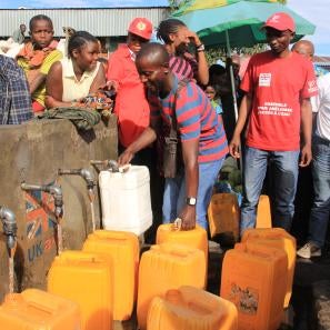People get water from a tap in dr congo