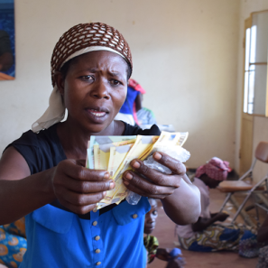 A woman in dr congo holds cash in her hands