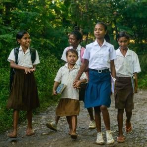 Lourdes walks to school in the company of younger classmates in timor leste