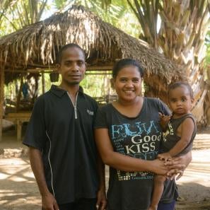 A man and woman holding a baby in timor leste