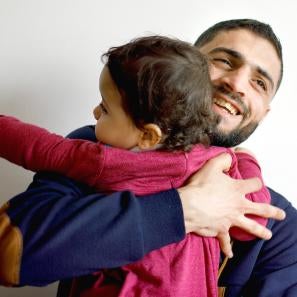 Father hugging child.