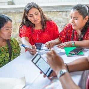 Farmers sitting at a table during a workshop.