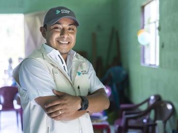 Member of Prosper Global's Guatemalan team smiling indoors with arms crossed.